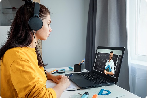 Woman learning online with laptop and headphones